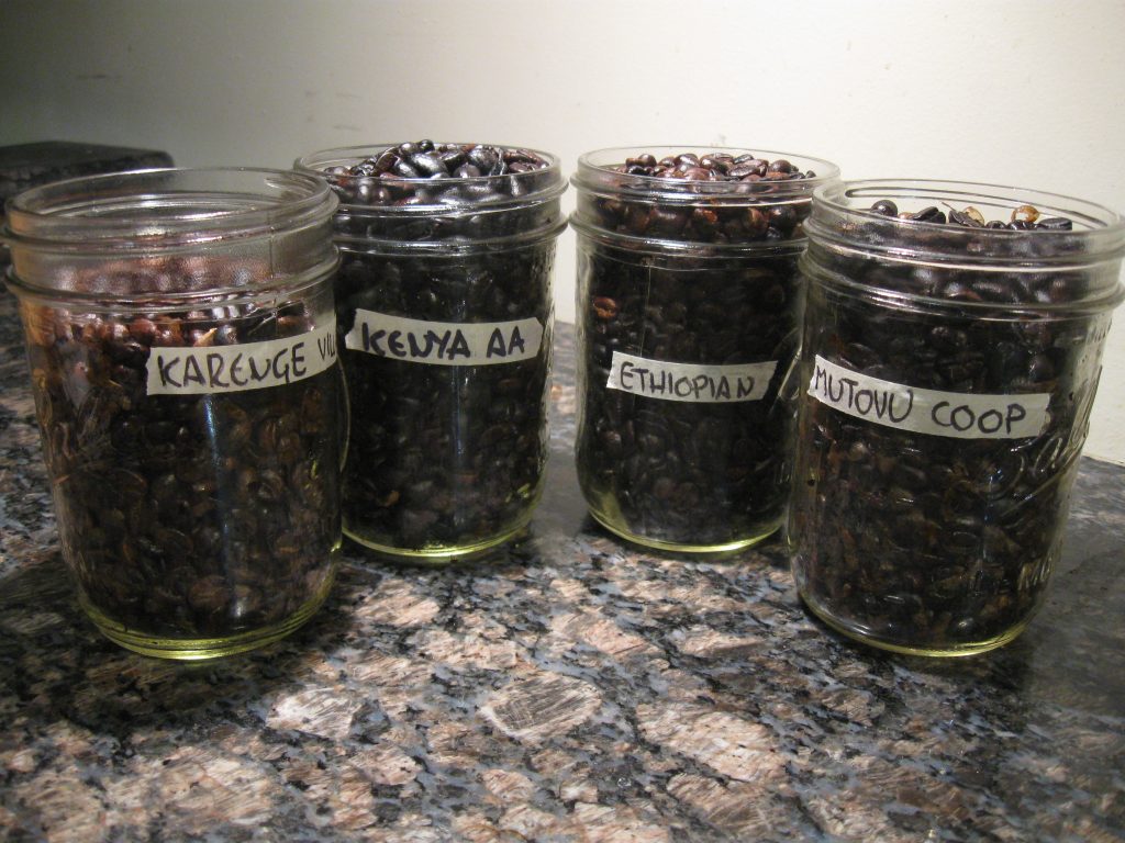 Four batches of home roasted coffee beans, each with a different country or origin.