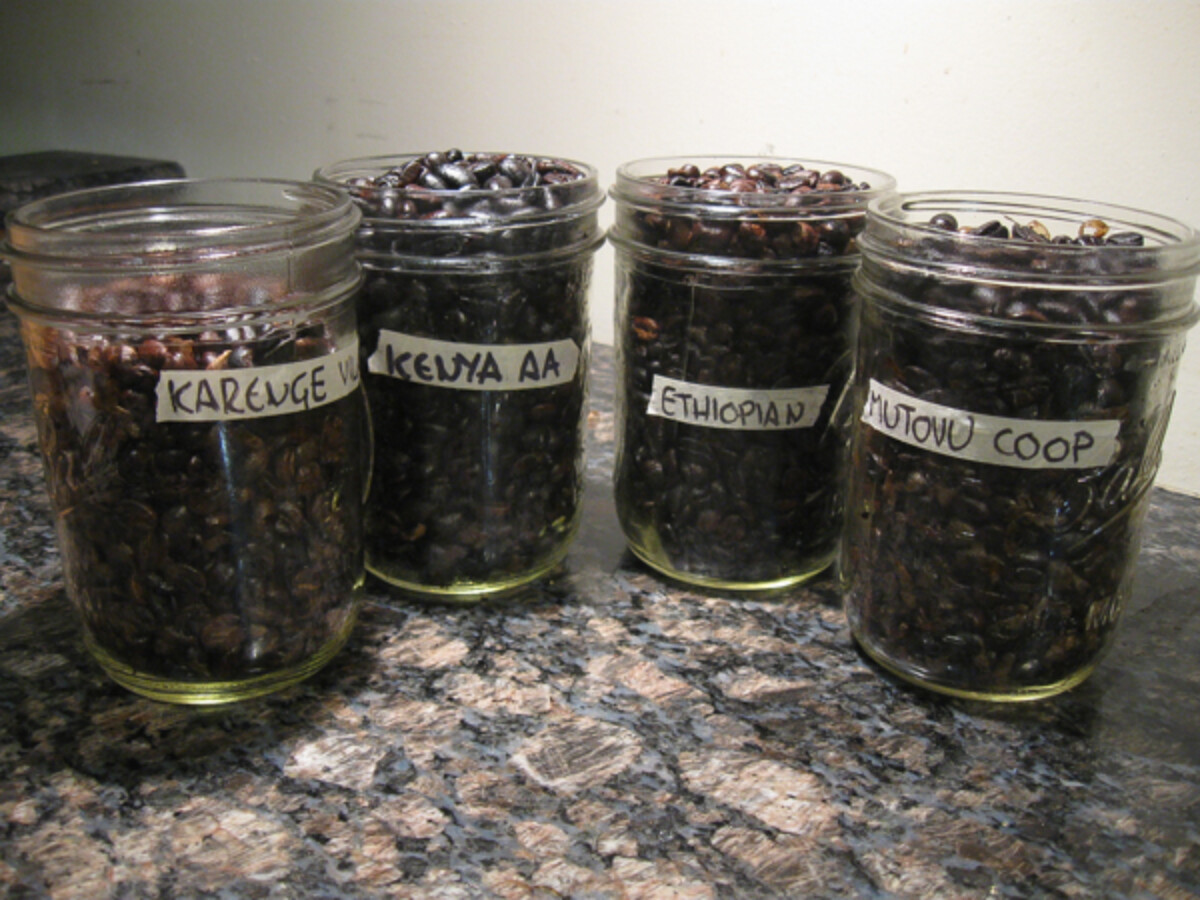 Four batches of home roasted coffee beans, each with a different country or origin. Off-gassing overnight on the counter.