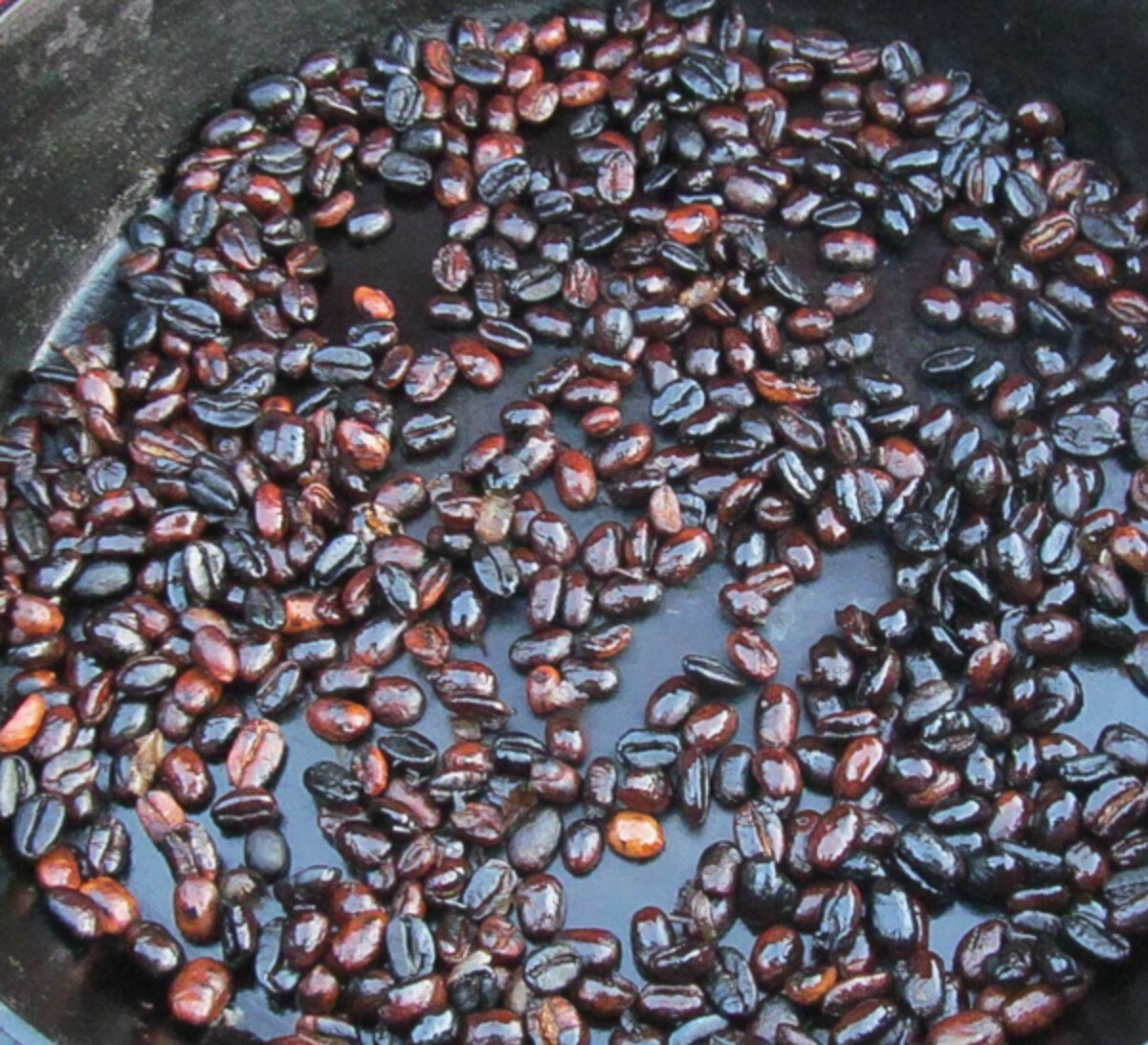 Coffee Beans Roasting in a Cast Iron Pan