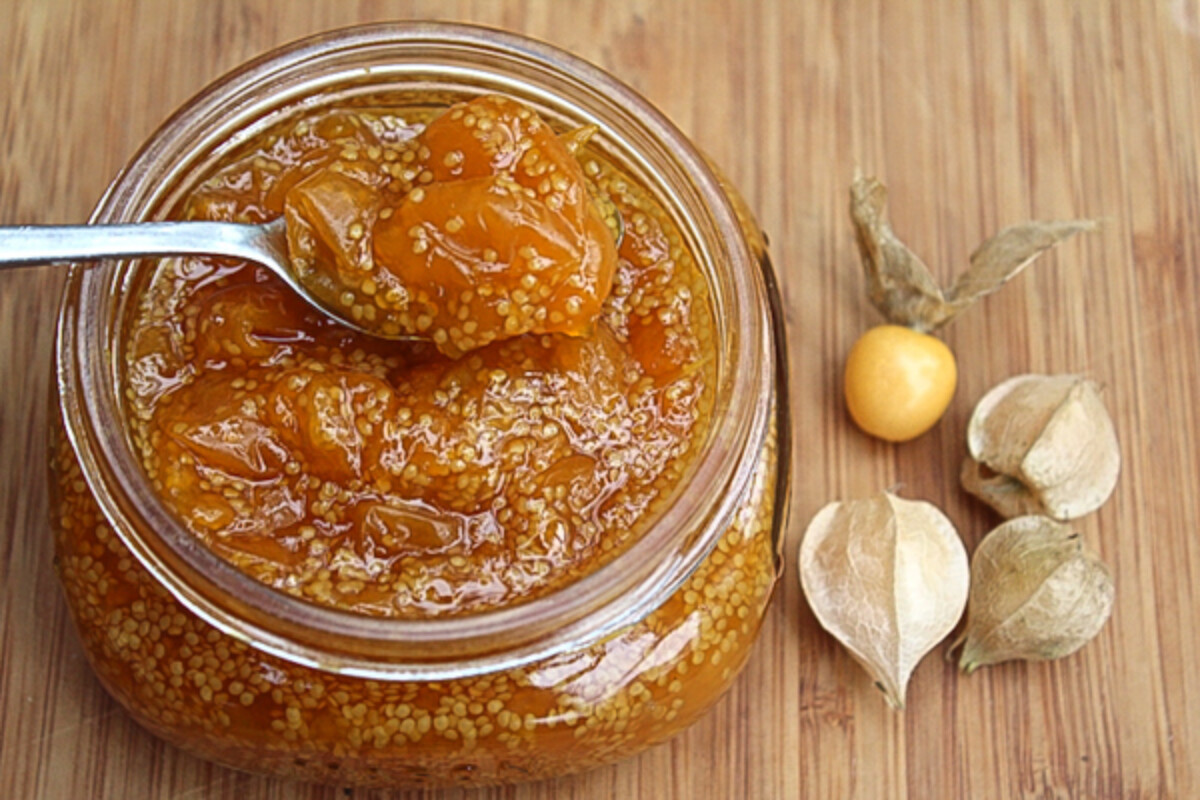 Open jar of homemade husk cherry jam