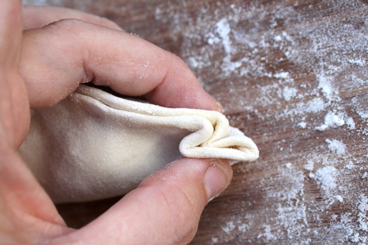 Folding the dumpling wrapper