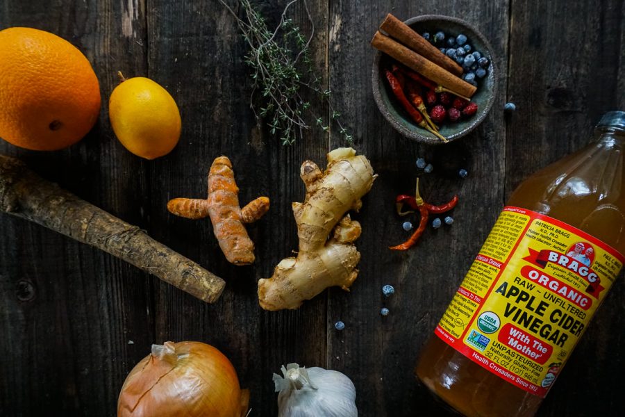 assorted ingredients to make fire cider arranged on a table