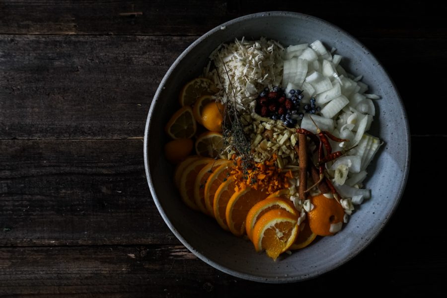 Fire cider ingredients prepared in a bowl before infusing
