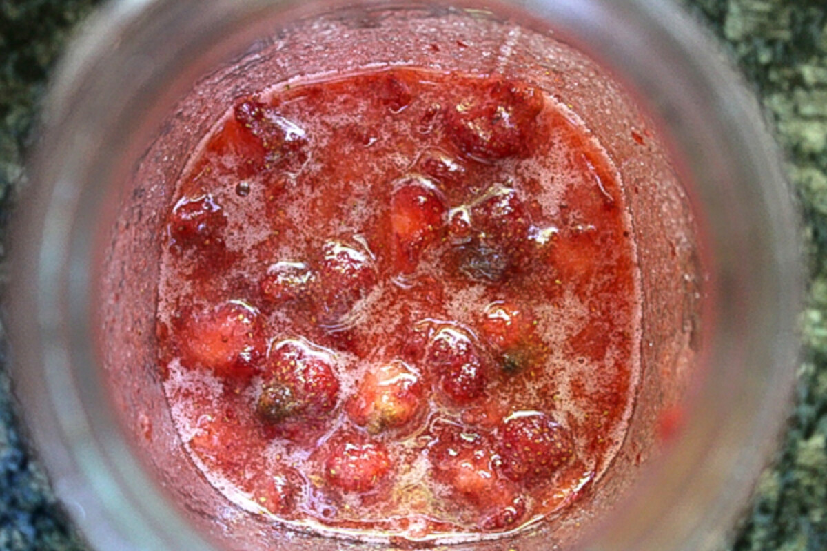Juicing Strawberries in sugar for wine