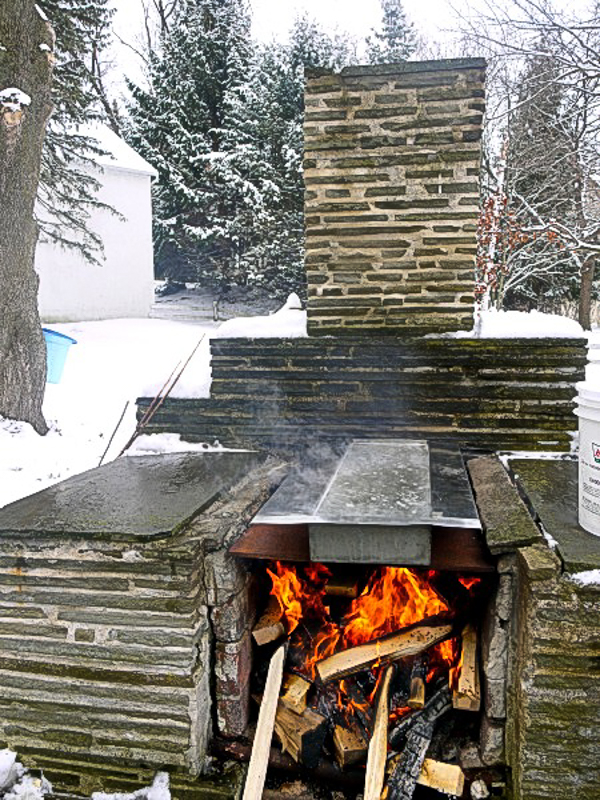 boiling maple sap outdoors for maple syrup