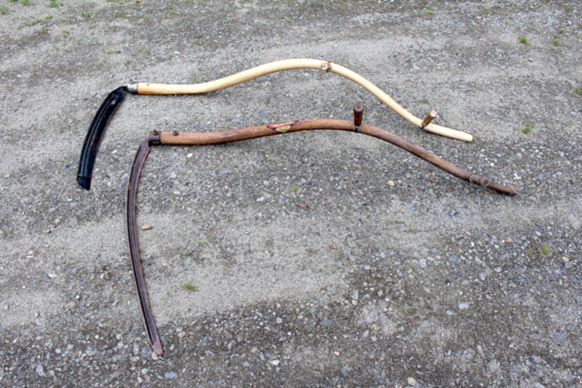Two American style curved snaths (scythe handles).