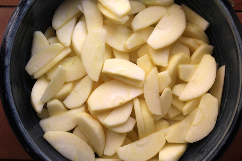 Raw apple slices in a bowl ready for blanching, the first step in canning apple pie filling at home.