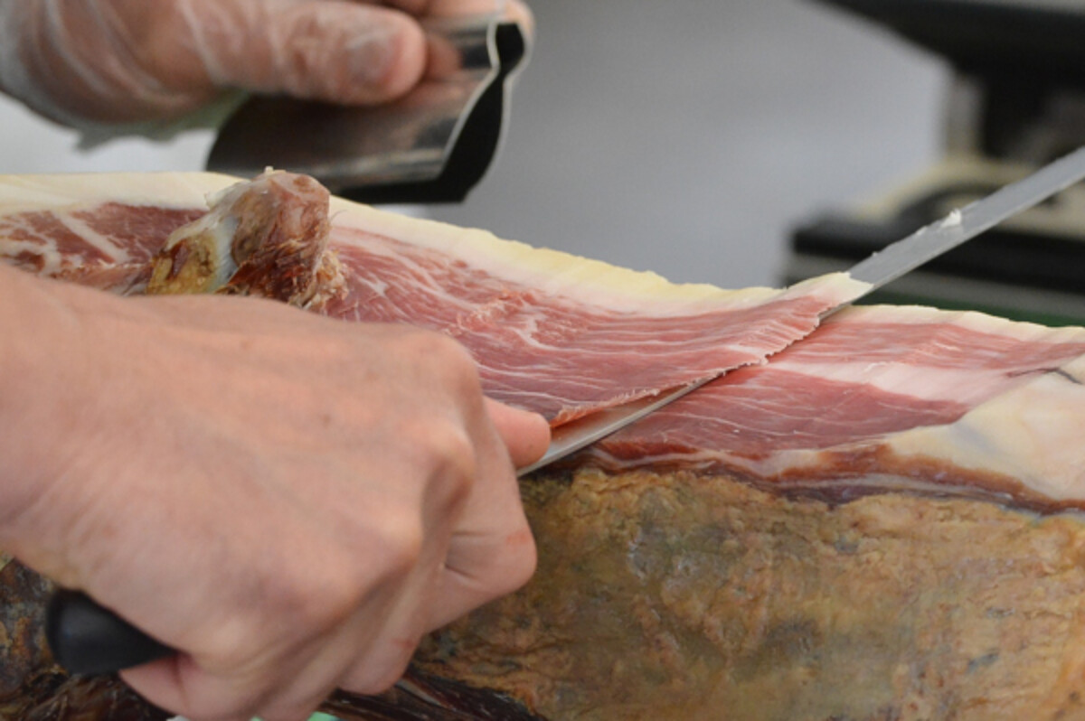 Slicing a cured ham.