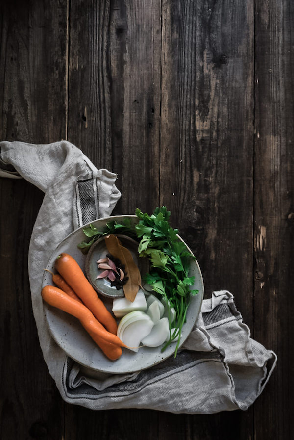 a bowl of carrots, onions, parsley and spices