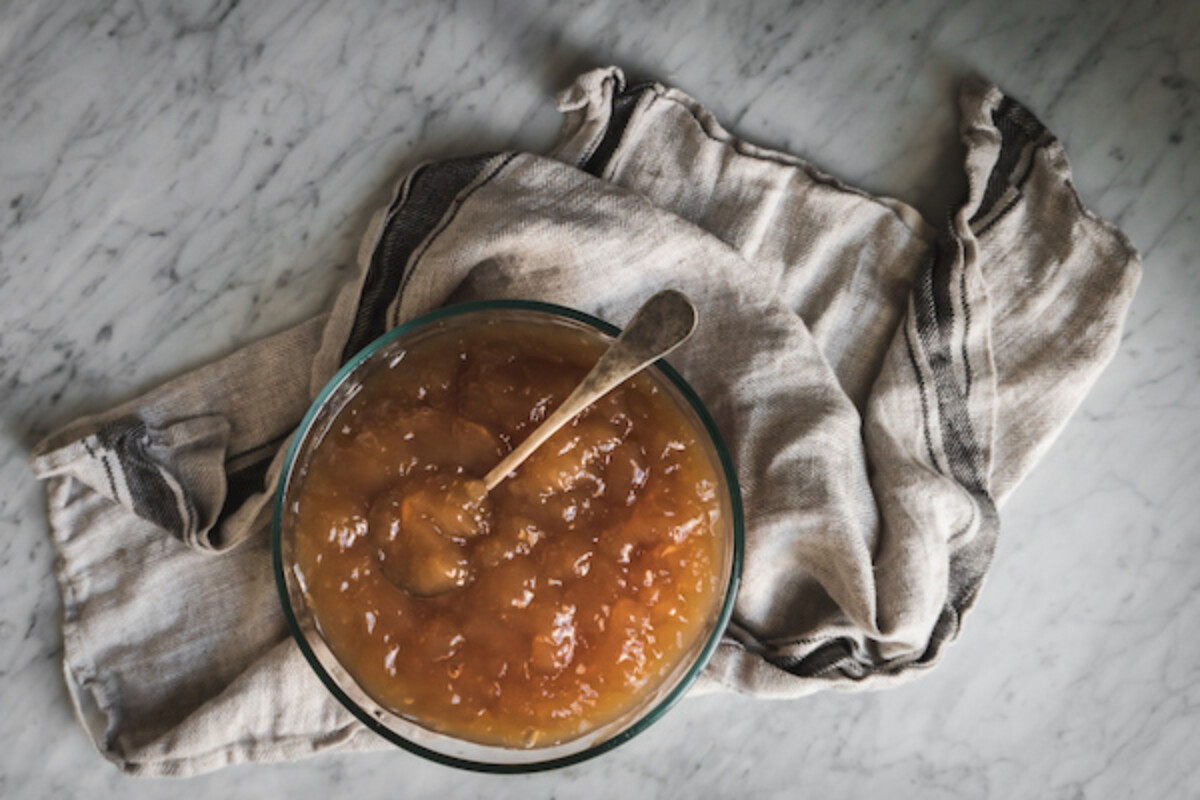 a bowl of gelatinous bone broth on white marble counter