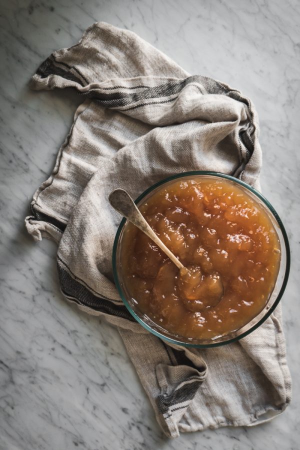 a bowl of gelatinous bone broth on white marble counter