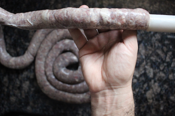 Stuffing lamb sausage into casings