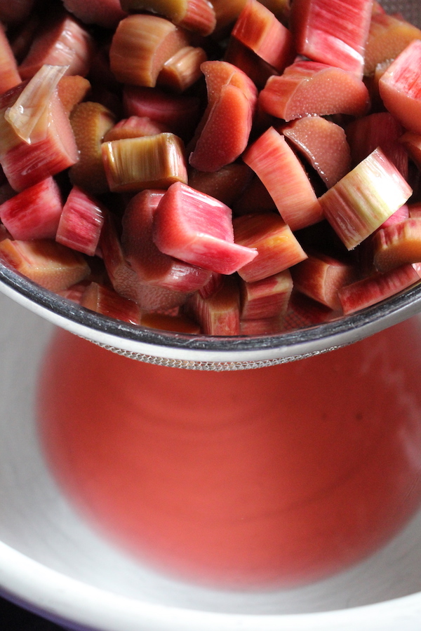 Straining rhubarb juice after it's been macerating in sugar overnight. This is the first step to making rhubarb jam.