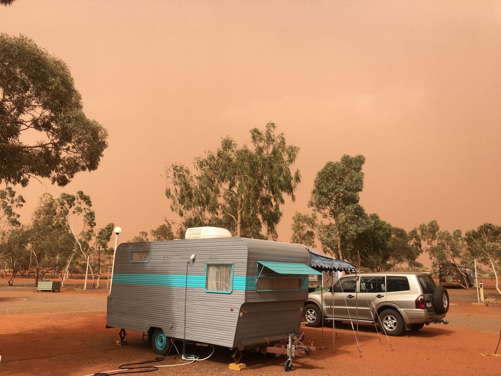 camper in dust storm for worldschooling family in Australia