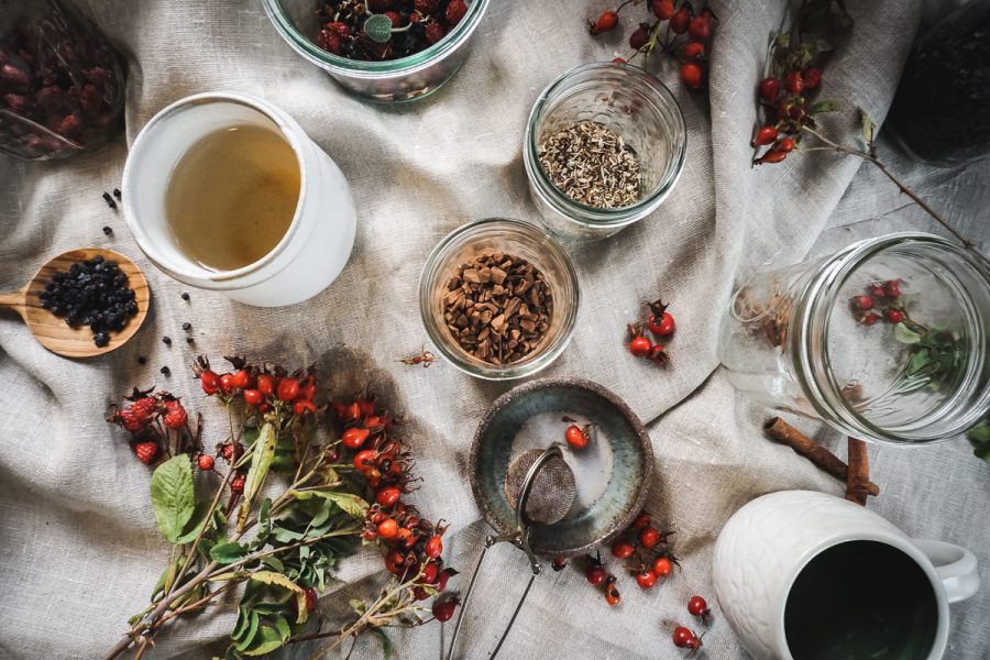 Ingredients for rose hip immunity tea spread out on a table.