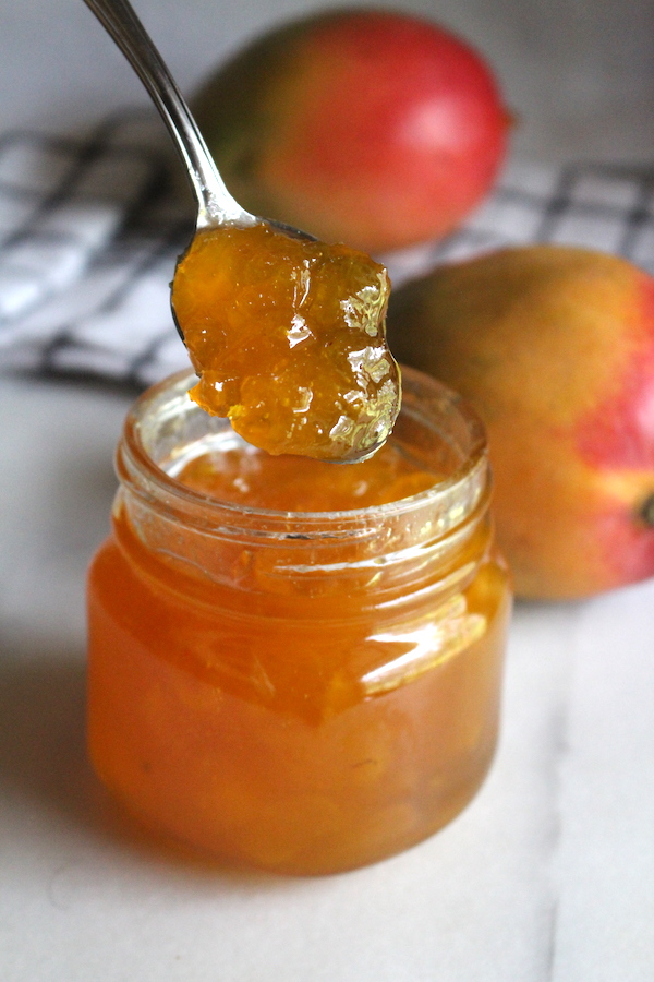 Homemade Mango Jam ~ a homemade jam made with just mango, sugar and a bit of citrus juice. This simple jam is bright and sunny, and perfect for home canning. It can also be preserved as a refrigerator jam.
