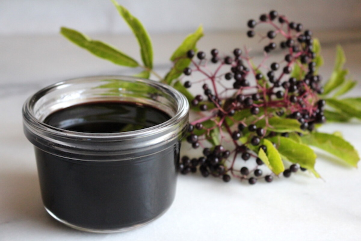 Jar of homemade elderberry syrup with raw honey