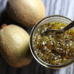 open jar of homemade kiwi jam showing the thick texture without added pectin