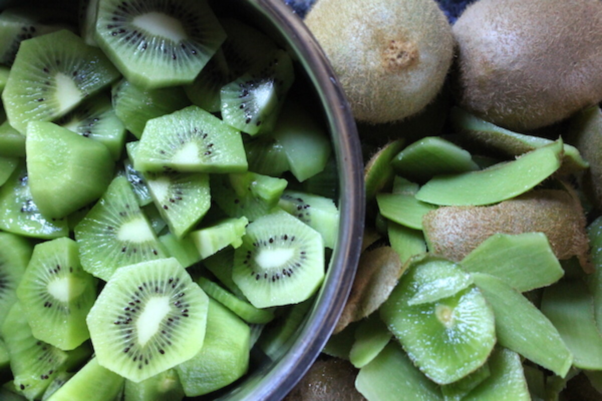 Kiwis chopped up in a pot to make kiwi jam
