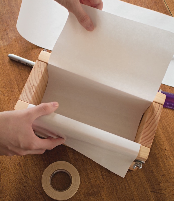 Lining a wooden soap mold with parchment paper