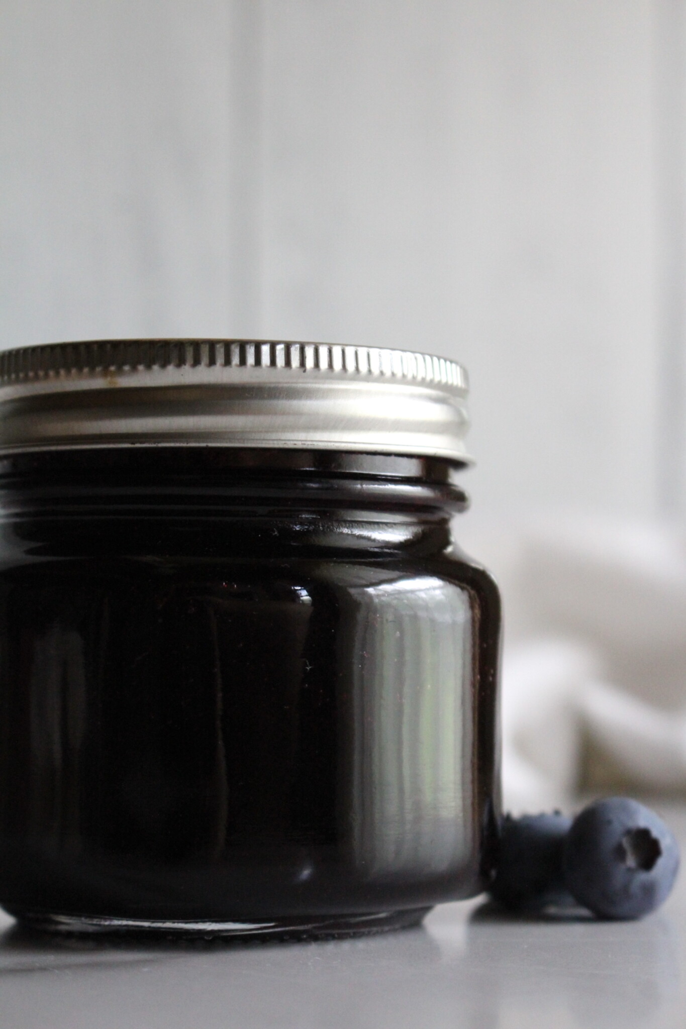 Canning jars of blueberry jelly