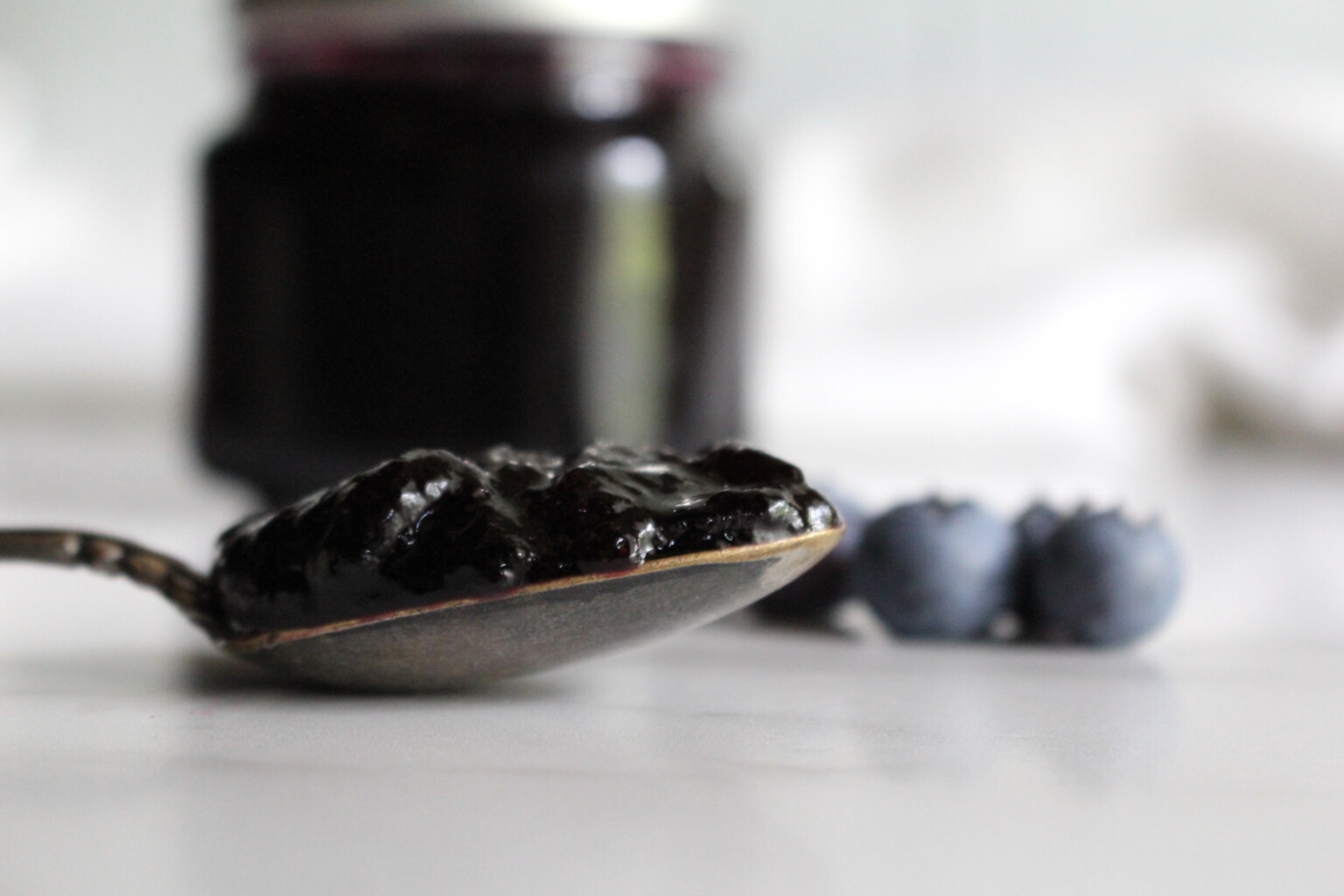 Blueberry jelly coating a spoon
