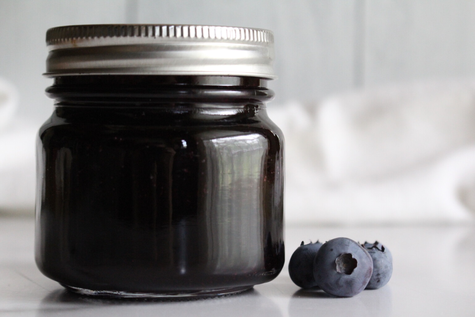 Finished jars of canned blueberry jelly
