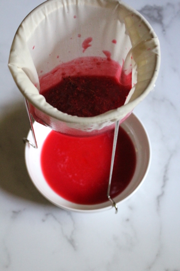 Straining redcurrant jelly through a jelly bag