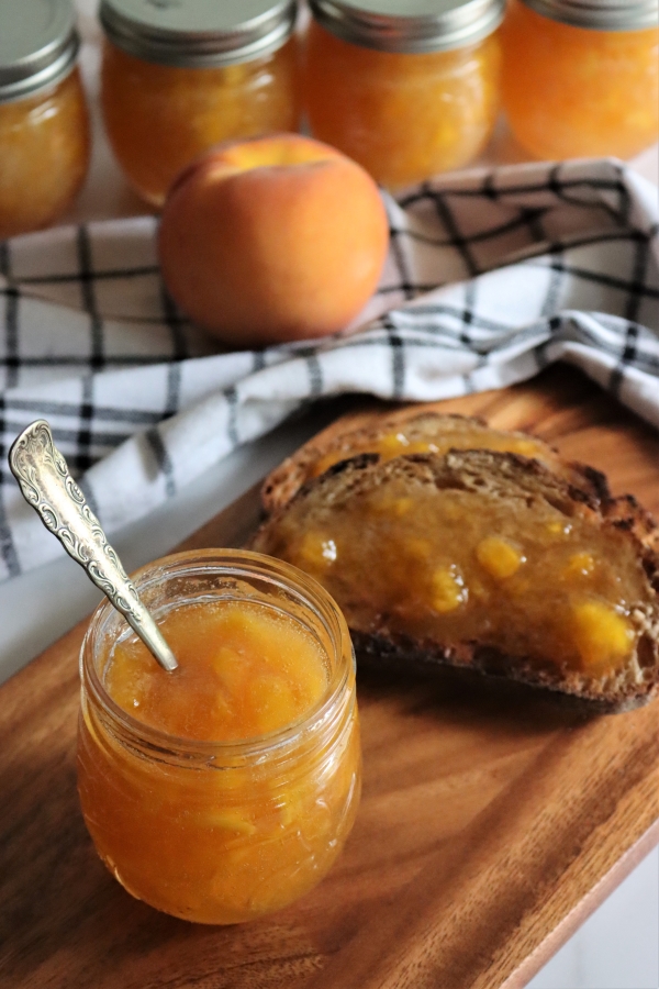 Serving homemade peach jam on toast