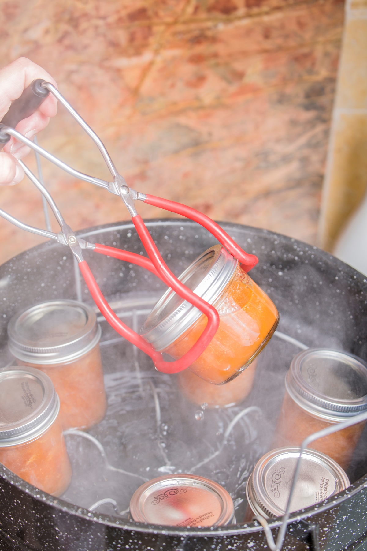 Lifting Jars from a Water Bath Canner with Jar Lifter