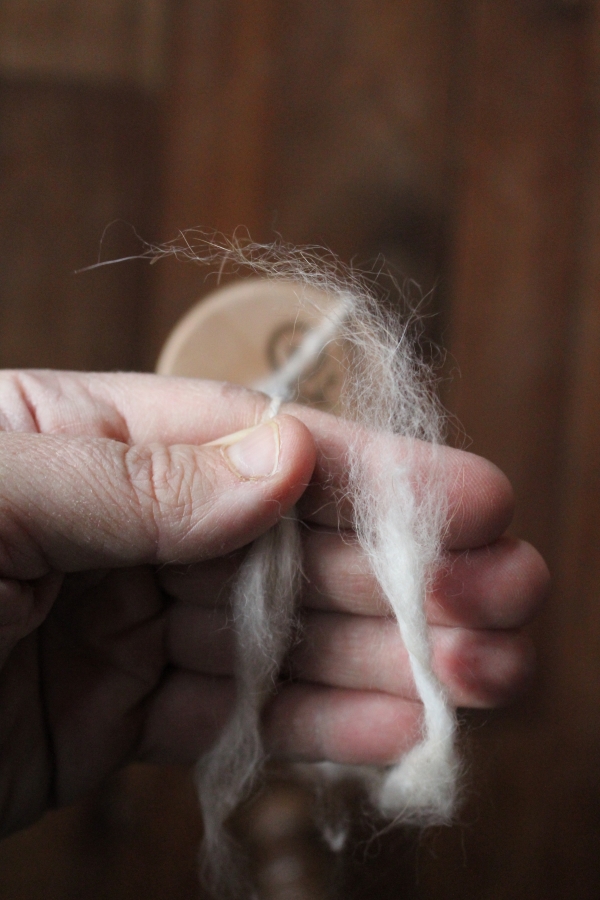 Marrying Angora Fiber after a break on a drop spindle