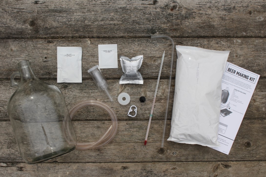 The contents of a one-gallon beer making kit contains everything you need to make a simple homemade beer.