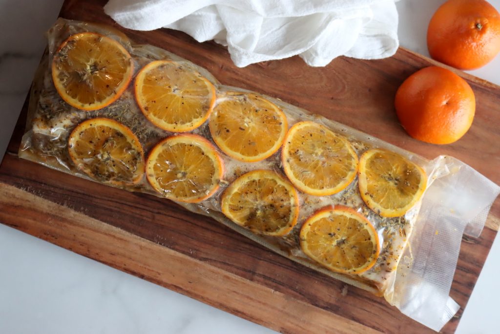 Pork Loin in a Vacuum Sealer Bag with orange slices, fennel and salt