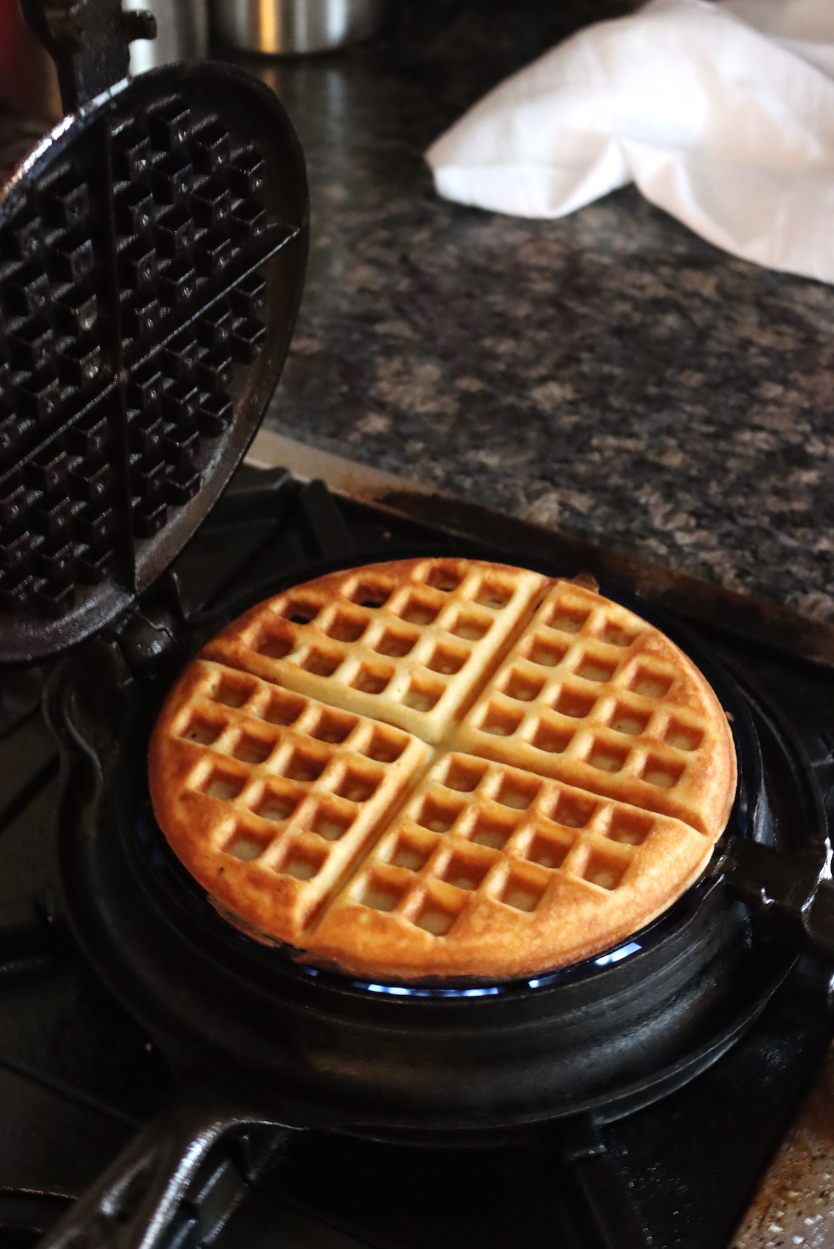Cooking waffles on a stovetop cast iron waffle maker