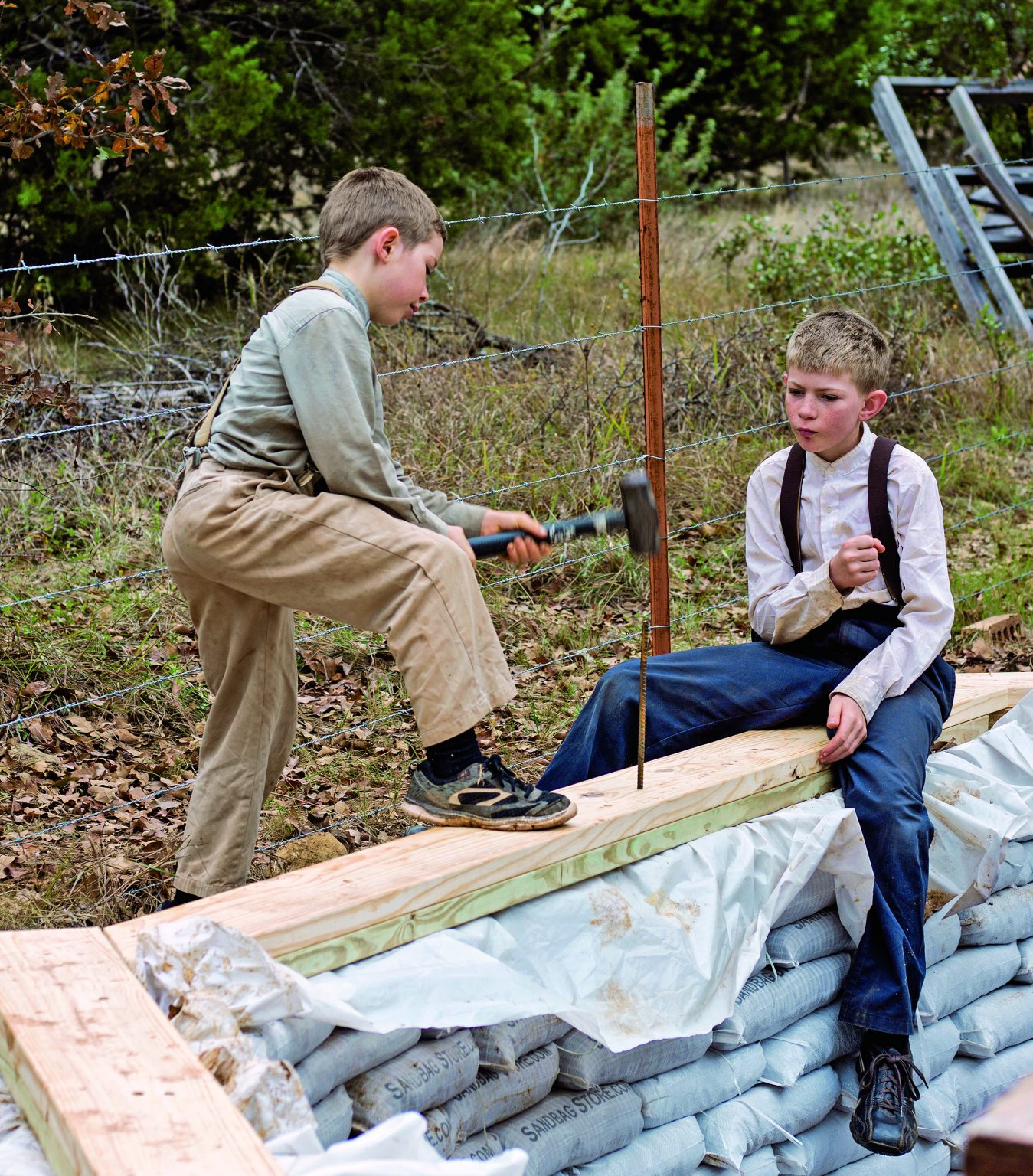 Pound the rebar through wooden bond beams into the earthbags.