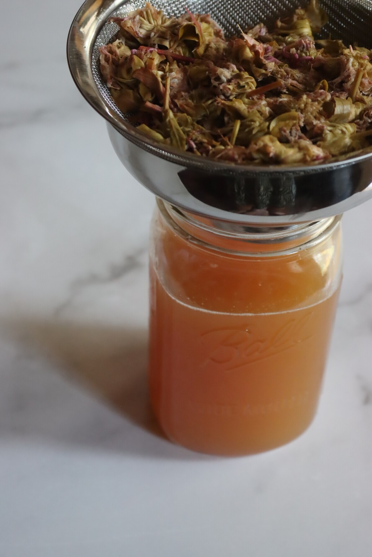 Straining Herbal Oxymel