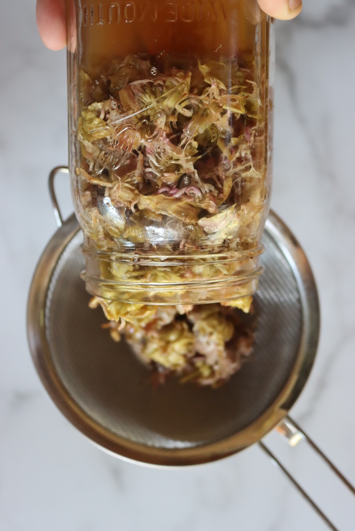 Straining Herbal Oxymel