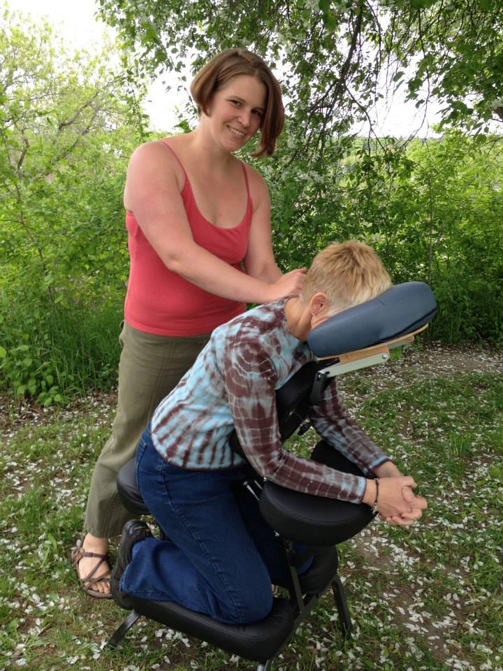 Ashley Adamant doing chair massage at a local farm fundraiser.